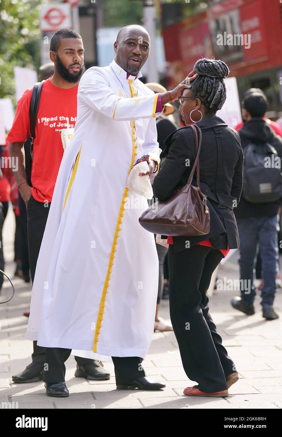 Bishop Climate Wiseman, 46, with a supporter outside Inner London Crown Court, where he is charged with fraud and unfair trading offences over the selling of 'plague protection kits' with claims a mixture made from oil and red string, was a cure for Covid-19. Picture date: Monday September 13, 2021. Stock Photo