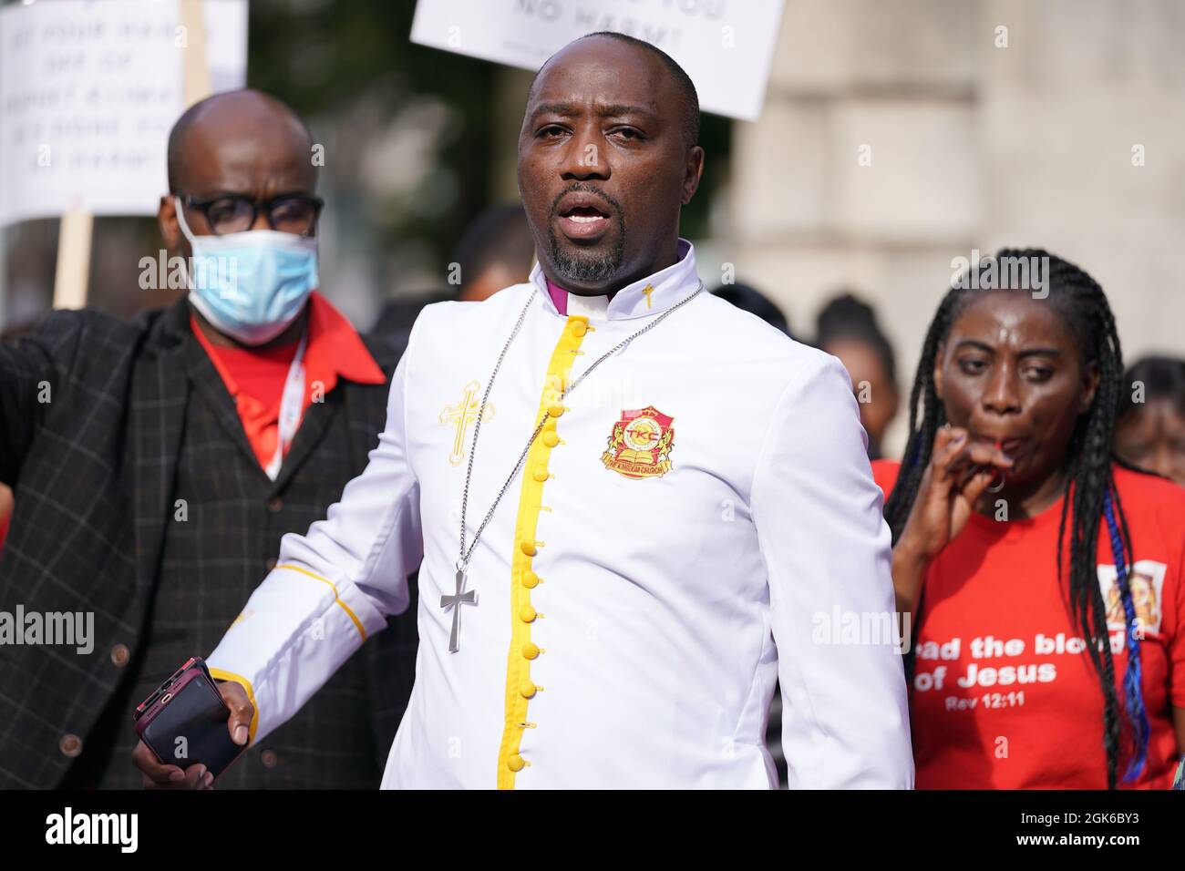 Bishop Climate Wiseman, 46, is greeted by his supporters outside Inner London Crown Court, where he is charged with fraud and unfair trading offences over the selling of 'plague protection kits' with claims a mixture made from oil and red string, was a cure for Covid-19. Picture date: Monday September 13, 2021. Stock Photo