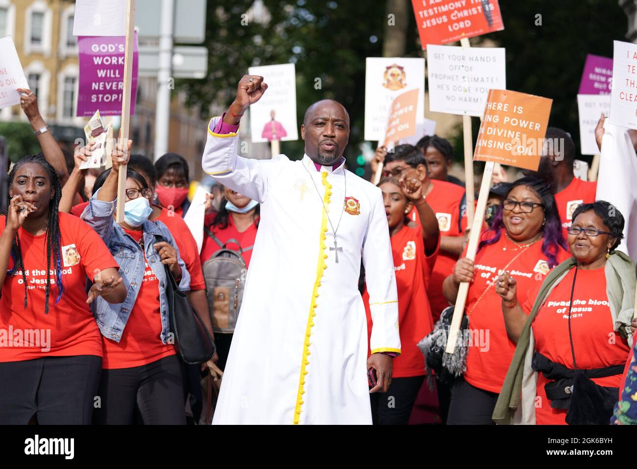 Bishop Climate Wiseman, 46, is greeted by his supporters outside Inner London Crown Court, where he is charged with fraud and unfair trading offences over the selling of 'plague protection kits' with claims a mixture made from oil and red string, was a cure for Covid-19. Picture date: Monday September 13, 2021. Stock Photo