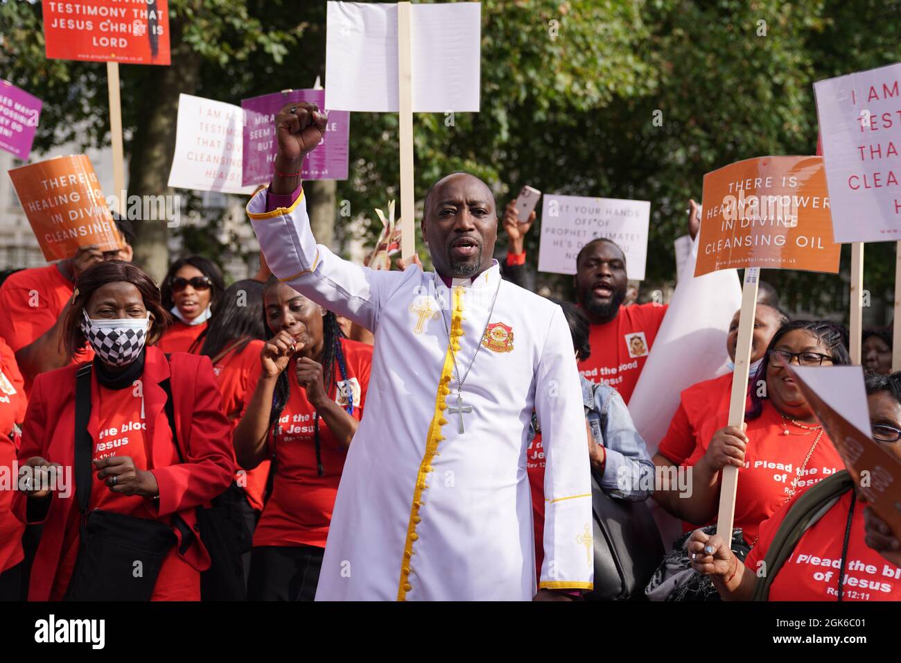 Bishop Climate Wiseman, 46, is greeted by his supporters outside Inner London Crown Court, where he is charged with fraud and unfair trading offences over the selling of 'plague protection kits' with claims a mixture made from oil and red string, was a cure for Covid-19. Picture date: Monday September 13, 2021. Stock Photo