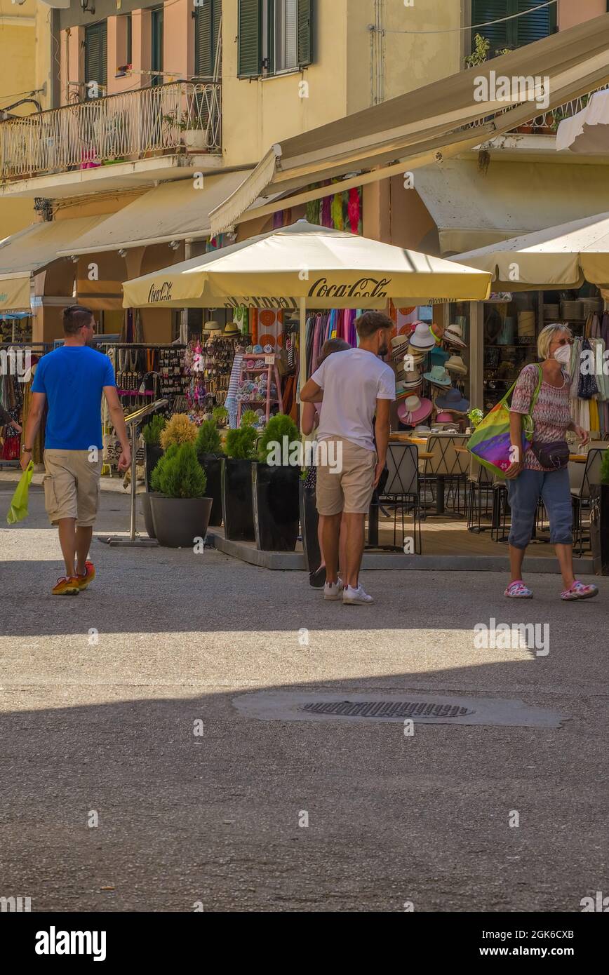 Busy street scenes in Corfu town with shops buildings people and narrow streets Stock Photo