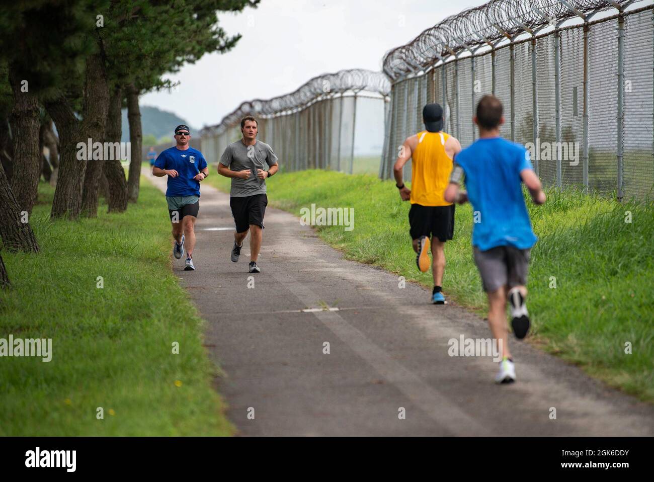 Airmen run to celebrate the life and legacy of Capt. William “Pyro” DuBois, F-16 fighter pilot, during Pyro’s “Push It Up” Trail Run at Kunsan Air Base, Republic of Korea, Aug. 14, 2021. For the last seven years, friends, family and fellow Airmen have organized trail runs in his honor every Aug. 14th, DuBois birthday. In keeping with tradition, the runs vary in length from 3.5k, 7.7k or 13k distances. Stock Photo