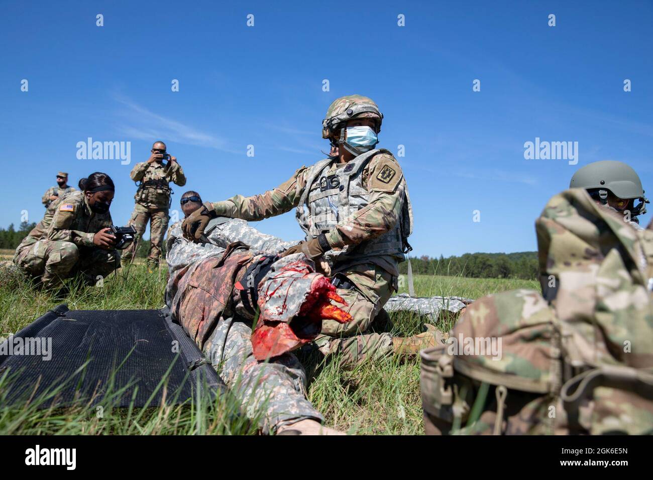 U.S. Army Reserve Pfc. Emonie Jones, a medic from the 396th Medical Company (Ground Ambulance) , loads a training dummy onto a litter during a mass casualty training at Fort McCoy, Wisconsin, Aug. 14, 2021. The event, a response to a downed C-130 Hercules Transport Aircraft, is a part of Global Medic 2021, an initiative to put medics in realistic scenarios that force them to rely on all of their skills in chaotic situations. Stock Photo