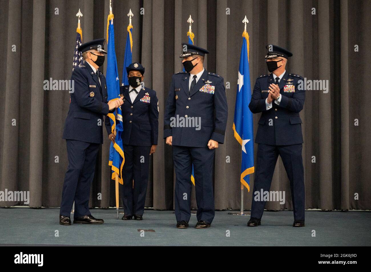 Gen. Tim Ray, left, commander of Air Force Global Strike Command, and Lt. Gen. (select) Mark Weatherington, right, outgoing 8th Air Force and Joint-Global Strike Operations Center commander applaud Maj. Gen. Andrew Gebara, incoming 8th Air Force and J-GSOC commander during a change of command ceremony at Barksdale Air Force Base, La., August 16, 2021. A change of command is a military tradition that represents a formal transfer of authority and responsibility for a unit from one commanding or flag officer to another. Stock Photo