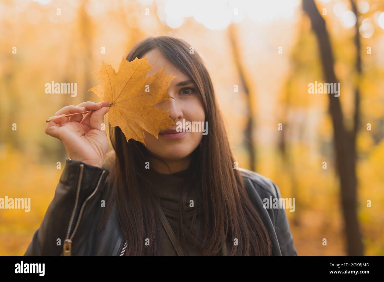 Portrait of autumn woman with fall leaf on nature background. Seasonal ...