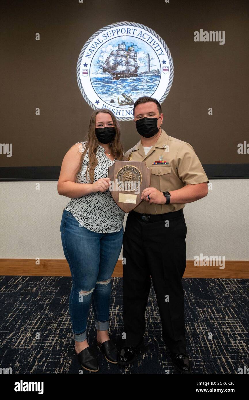 WASHINGTON, DC (Aug. 16, 2021) – Master-at-Arms 3rd Class Randy Harris (right) poses with his family member following an award ceremony held onboard Washington Navy Yard. Stock Photo