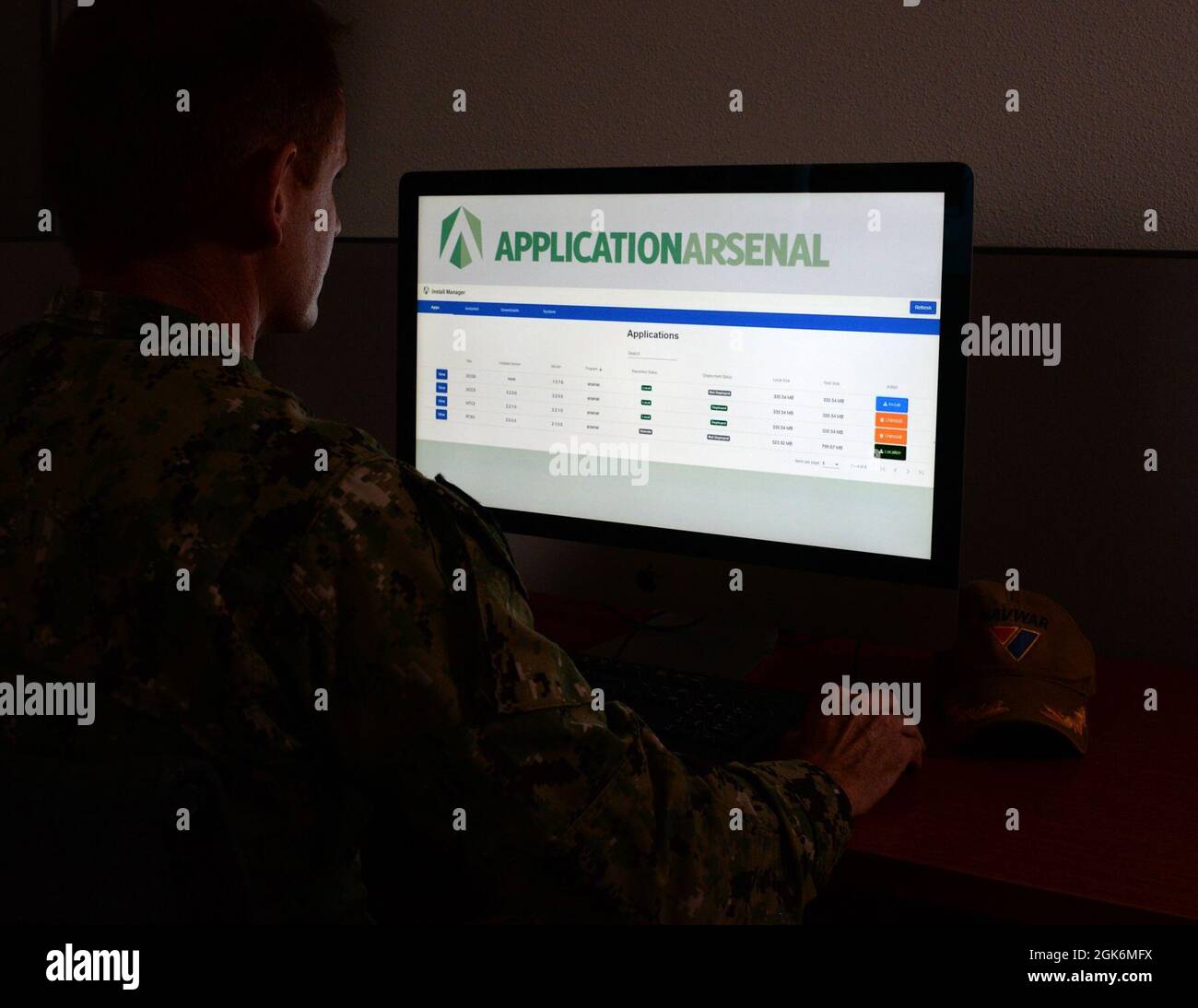 210817-N-UN340-001 SAN DIEGO (Aug. 17, 2021) U.S. Navy Cmdr. Sam Hallock, Project Overmatch Baseline Manager and Chief of Staff assigned to Naval Information Warfare Systems Commands (NAVWAR) accesses NAVWAR’s software application arsenal.  Recently deployed to the Pacific Regional Network Operations Center (PRNOC) in Hawaii, the application arsenal functions like a commercial app store, enabling fleet system administrators and operators to remotely search, discover, download, install and manage select platform applications at the speed of relevance. Stock Photo