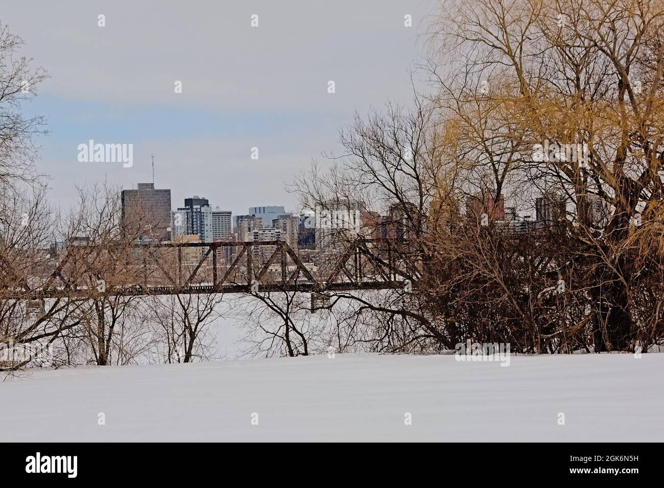 Prince of Wales rail bridge over frozen Ottawa river on a cold winter day between  Ontario and Quebec, with Gatineau office sksycrapers behind  in Can Stock Photo