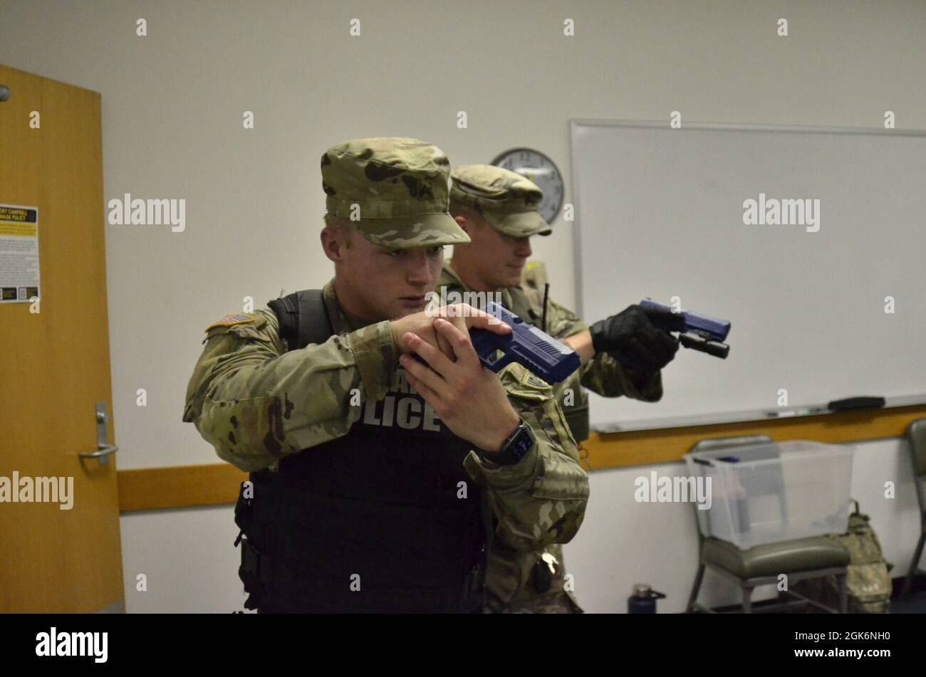 Corporal Kyle Crotty, 561st Military Police Company, 716th Military Police Battalion, left; and Sgt. Jason Wright, collision investigator, Installation Provost Marshal Office, secure a room at Building 6563 Aug. 17 during an active shooter scenario, which was conducted as part of a two-day full-scale exercise. Stock Photo