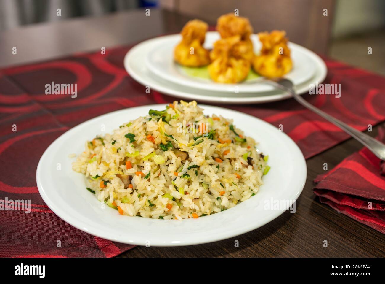 Served Chinese Rice Rice dish with assorted vegetables prepared and served on the table of ...