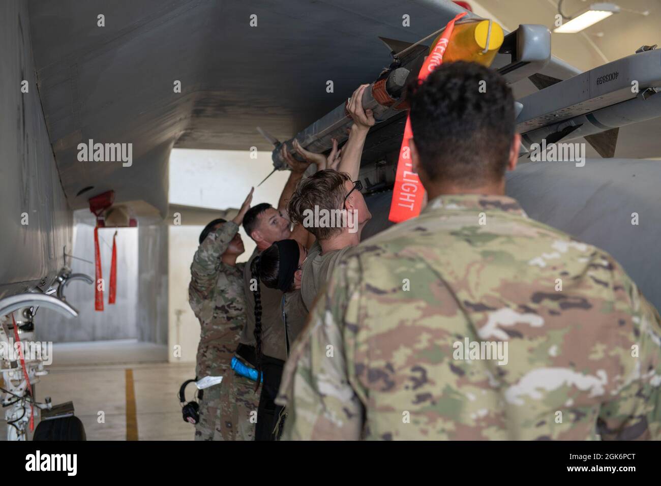 U.S. Air Force Airmen from the 44th Aircraft Maintenance Unit load a ...
