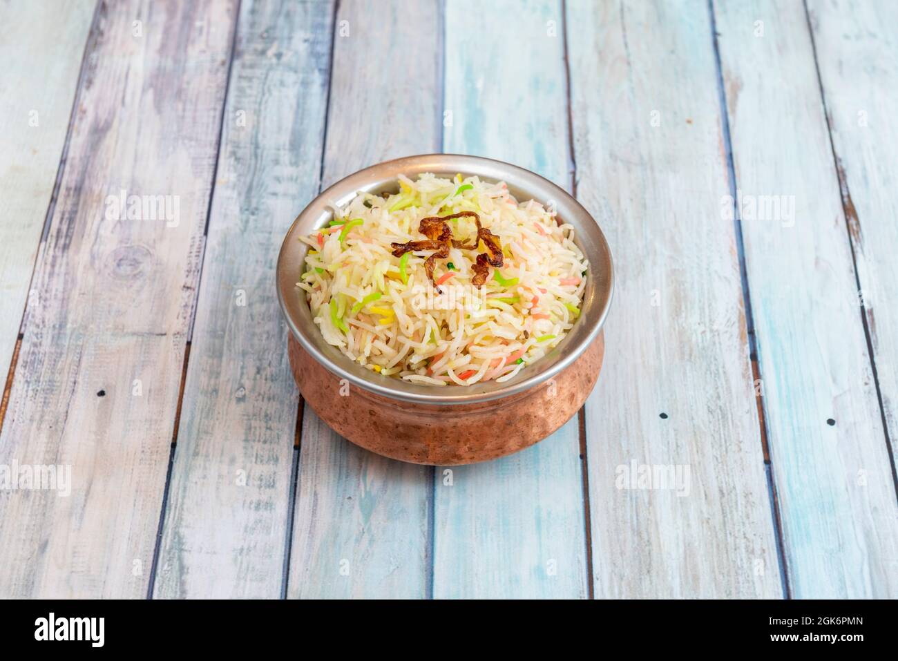 Traditional indian metal bowl with pilau rice in pakistani restaurant