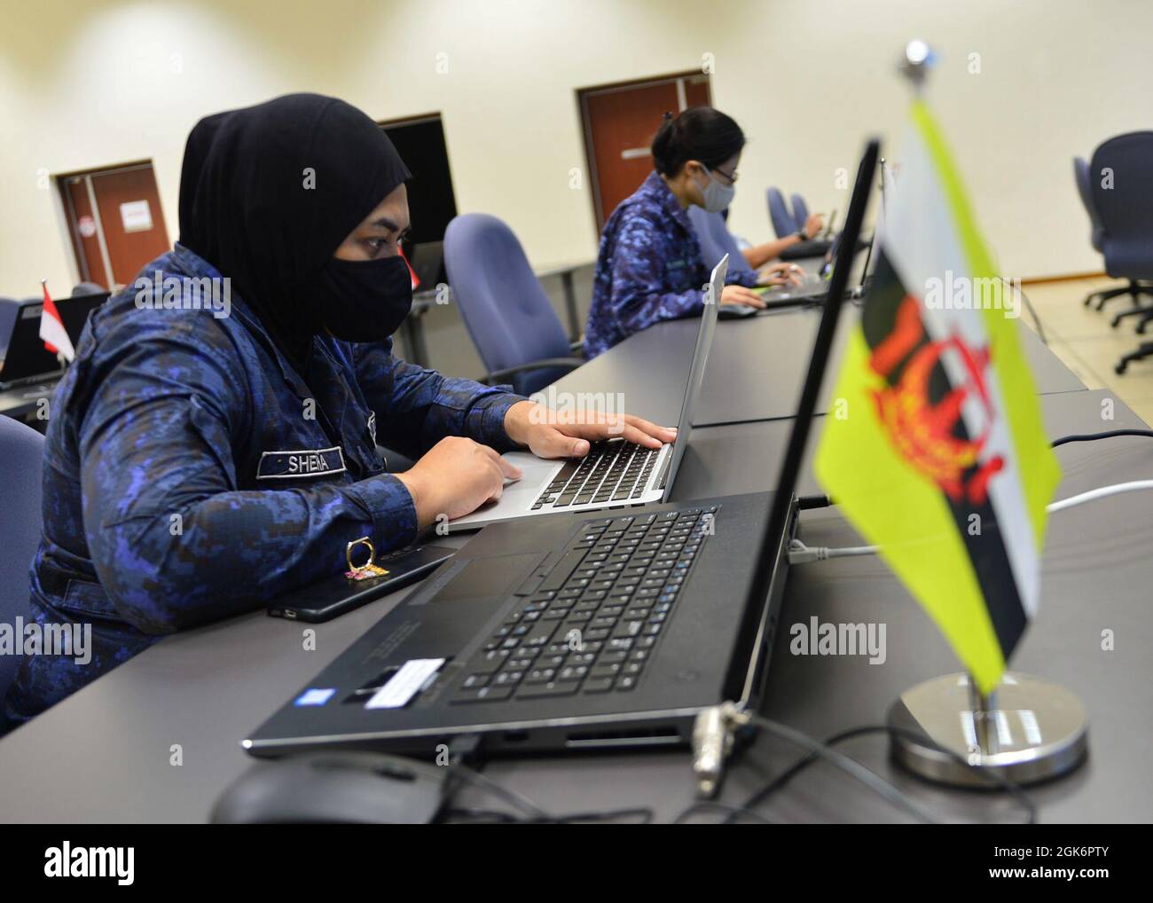 SINGAPORE (Aug. 18, 2021) – Royal Brunei Navy Lt. Sheha tracks vessels and analyses data during the Southeast Asia Cooperation and Training (SEACAT) 2021 command post exercise in the Changi Command and Control Centre at Changi Naval Base. In its 20th year, SEACAT is a multilateral exercise designed to enhance cooperation among 21 participating Southeast Asian countries and provide mutual support and a common goal to address crises, contingencies, and illegal activities in the maritime domain in support of a free and open Indo-Pacific. Stock Photo