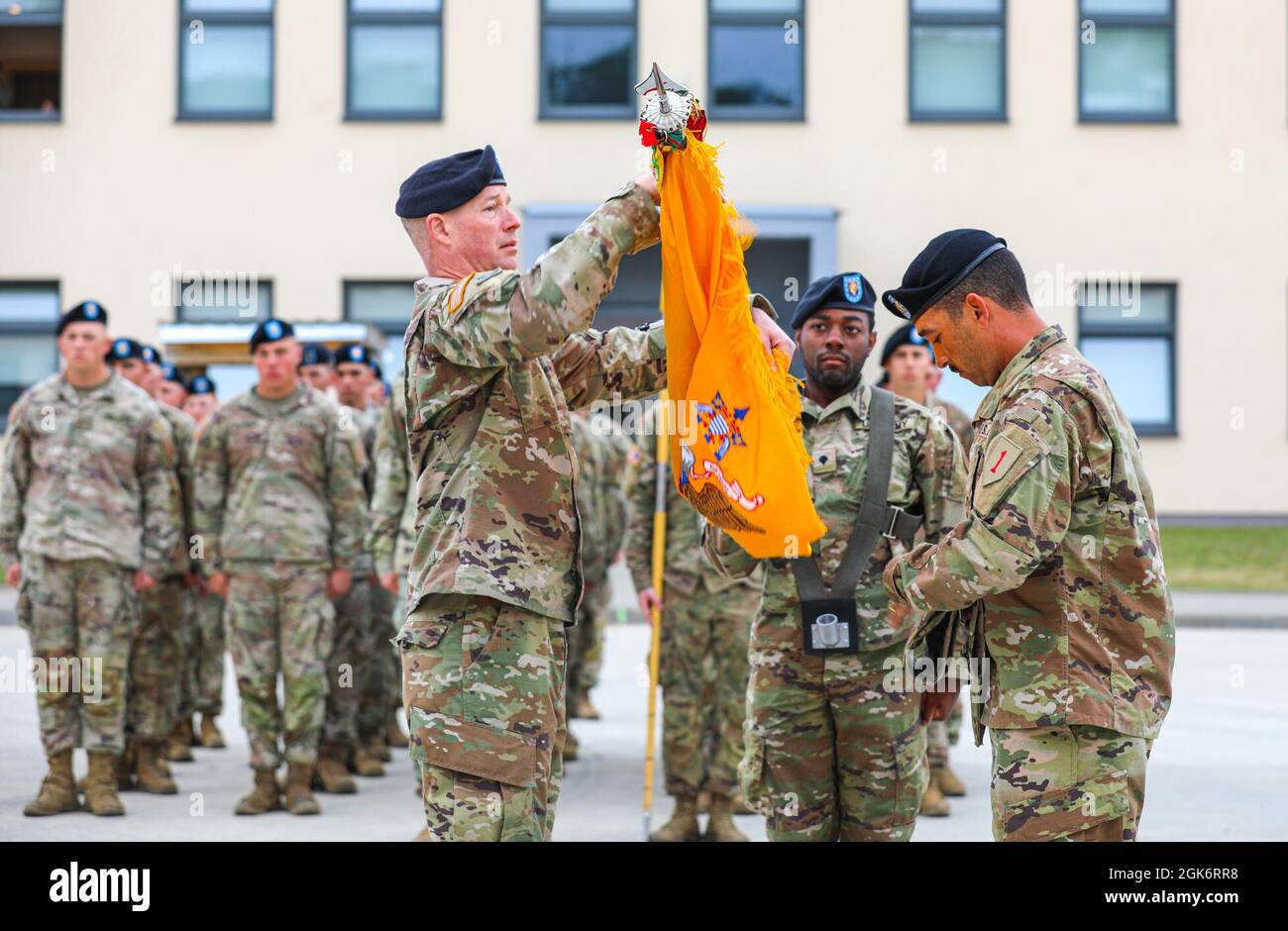 The 2nd Battalion 'Dreadnaught Battalion,' 34th Armored Regiment Commander Lt. Col. Kenneth Selby and Command Sgt. Maj. Christopher Albanese uncase their colors during a transfer of authority ceremony at Drawsko Pomorskie Training Area Poland, August 18, 2021. 'The uncasing of these colors is a time-honored tradition that this battalion has seen numerous times throughout the world, from Europe, Southeast Asia, the Middle East,' Selby said. 'The Dreadnaught Battalion has conducted this very ceremony with Soldiers just like you over the last 80 years all across this globe.' Stock Photo