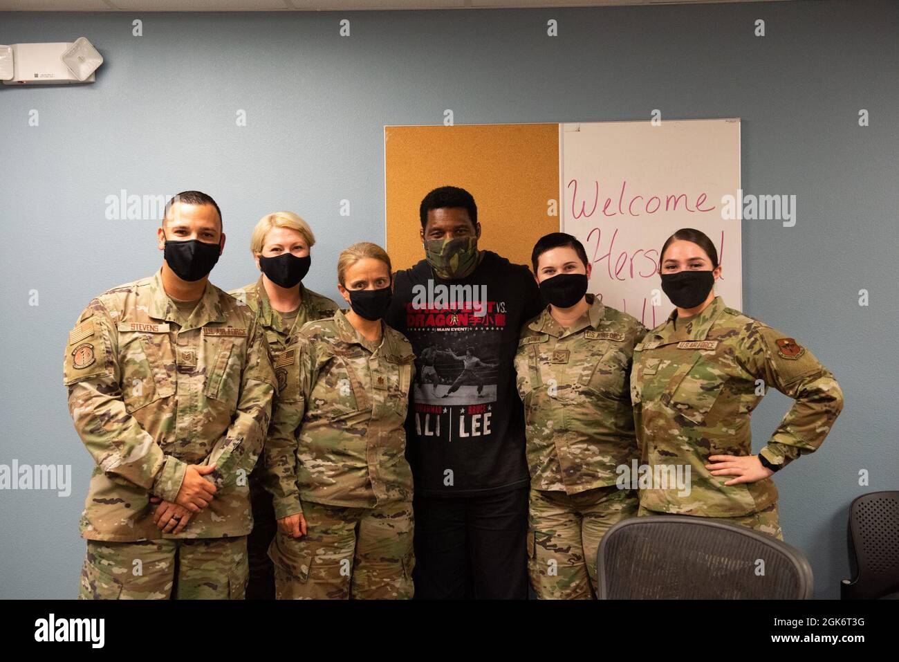 Herschel Walker poses with members of the 47th Medical Group on Aug. 18