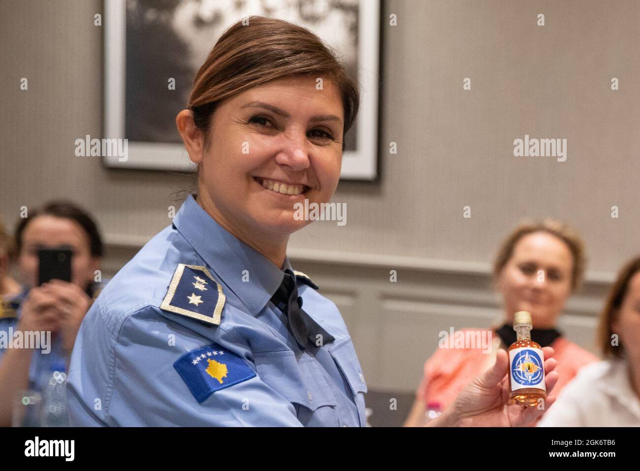 Keynote speaker, Kosovo Police Col. Aferdita Mikullovci, receives maple syrup as a token of appreciation during the Kosovo Police Women's Association, 'Leadership Training Day,' at the Villa Germia Restaurant Pristina in Pristina, Kosovo, Aug. 18, 2021. Stock Photo