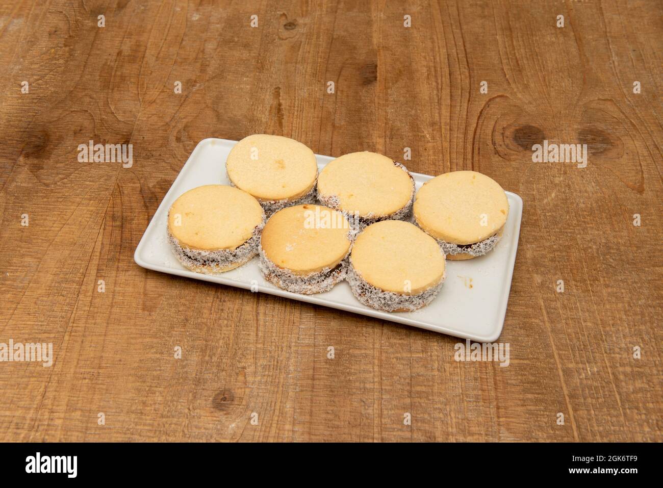 Tray of alfajores, typical tasteless Argentine sweet on wooden table Stock Photo