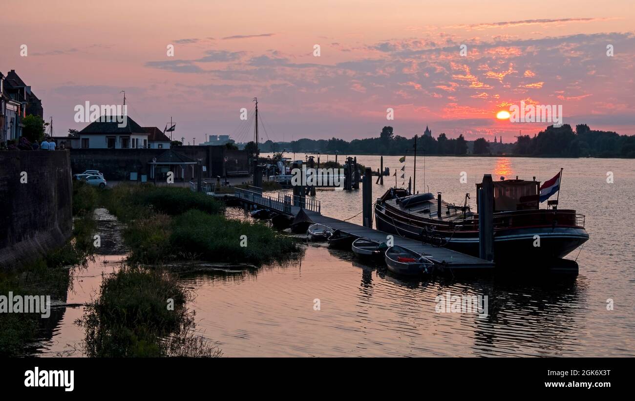 The harbor from Woudrichem at the river Merwede at sunset in the Netherlands Stock Photo