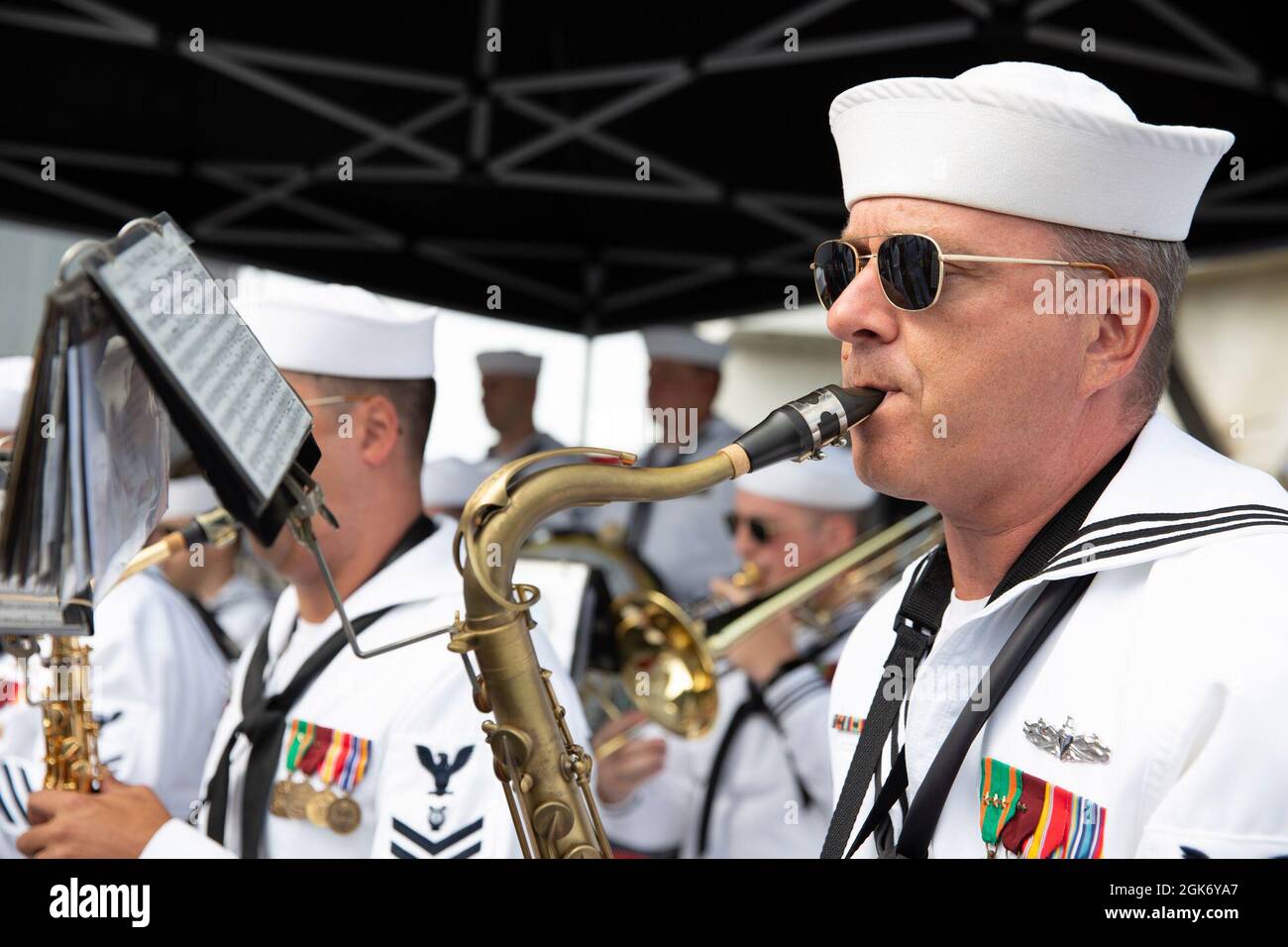 SAN DIEGO (Aug. 19, 2021) Sailors assigned to the Navy Band Commander, Navy Region Southwest, play music during a change of command ceremony aboard the aircraft carrier USS Abraham Lincoln (CVN 72). Capt. Walt “Sarge” Slaughter successfully completed his 26 month tour as commanding officer during which Abraham Lincoln completed a 10-month combat deployment, the largest carrier work package ever completed in San Diego, and returned to sea in preparation for an upcoming deployment amidst the COVID-19 pandemic. Slaughter was relieved by Capt. Amy Bauernschmidt. Stock Photo