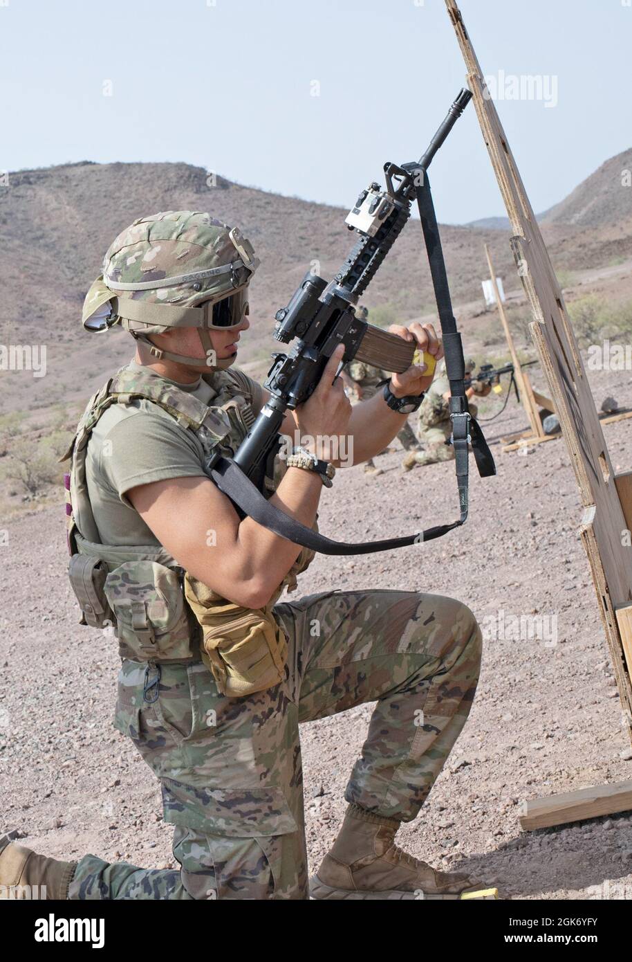 ARTA, Djibouti (August 19, 2021) U.S. Army Spc. Simon Galeano, from Norwalk, Conn., 1-102nd Infantry Regiment (Mountain), Task Force Iron Gray, Combined Joint Task Force – Horn of Africa (CJTF-HOA), reloads a magazine into his M4 rifle during a live-fire exercise at the Djiboutian Range Complex, Djibouti, Aug. 19, 2021. Galeano is currently stationed at Camp Lemonnier, Djibouti (CLDJ), which serves as an expeditionary base for U.S. military forces providing support to ships, aircraft and personnel that ensure security throughout Europe, Africa and Southwest Asia. CLDJ enables maritime and comb Stock Photo