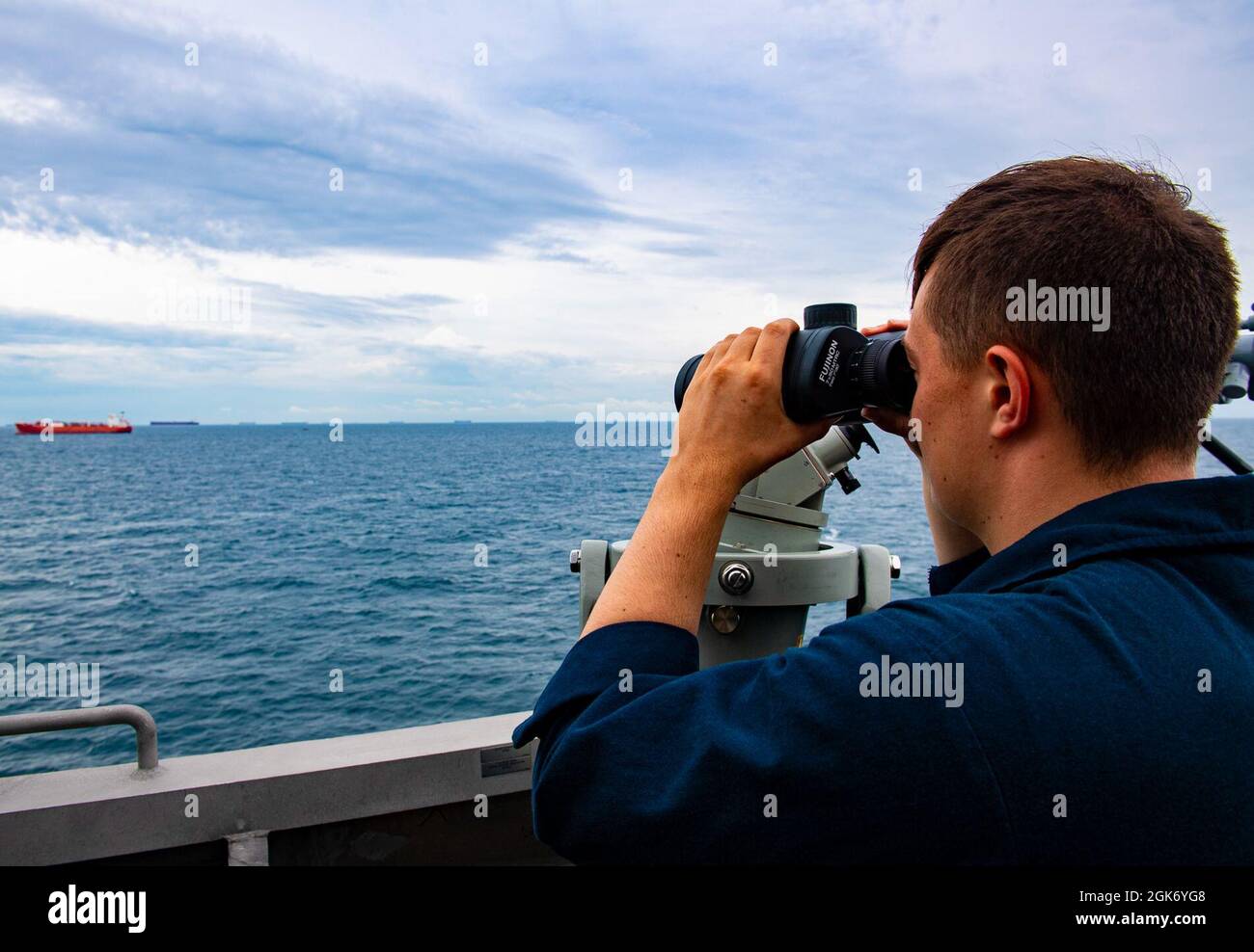 SOUTH CHINA SEA (AUG. 20, 2021) Mineman Seaman Caleb Hamrick from Colombus, Ohio, conducts watch standing duties during Southeast Asia Cooperation and Training (SEACAT) exercise, Aug. 20, 2021. In its 20th year, SEACAT is a multilateral exercise designed to enhance cooperation among 21 participating Southeast Asian countries and provide mutual support and a common goal to address crises, contingencies, and illegal activities in the maritime domain in support of a free and open Indo-Pacific. Stock Photo