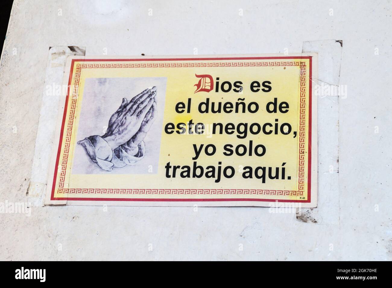 SUCHITOTO, EL SALVADOR - APRIL 9, 2016: Religious text on a wall of a restaurant in Suchitoto, El Salvador. It says: God is the owner of this enterpri Stock Photo