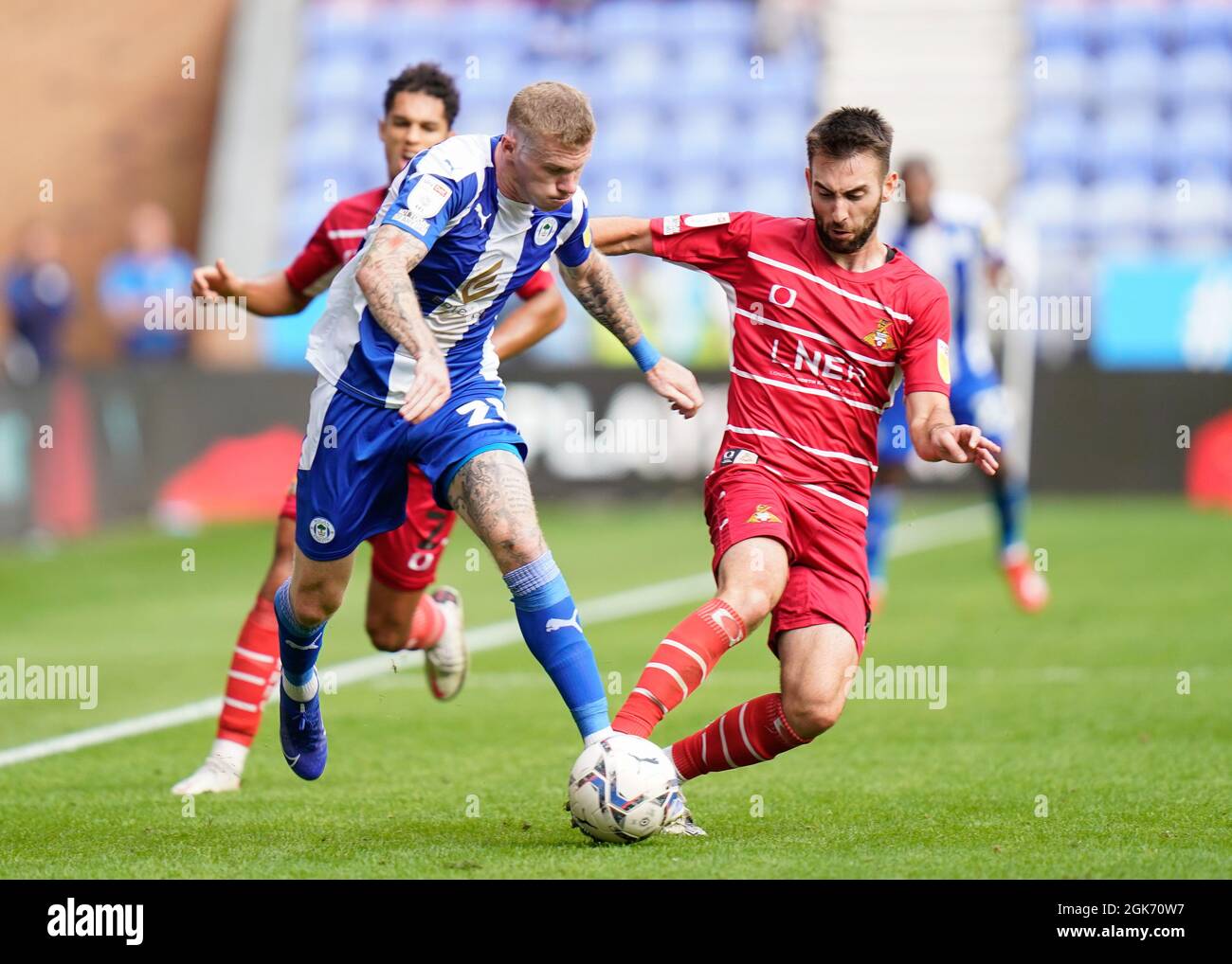 Doncaster's Ben Close competes for the ball with Wigan’s James McClean Wigan Athletic -V- Doncaster Rovers   at The DW Stadium, Wigan, Greater Manches Stock Photo