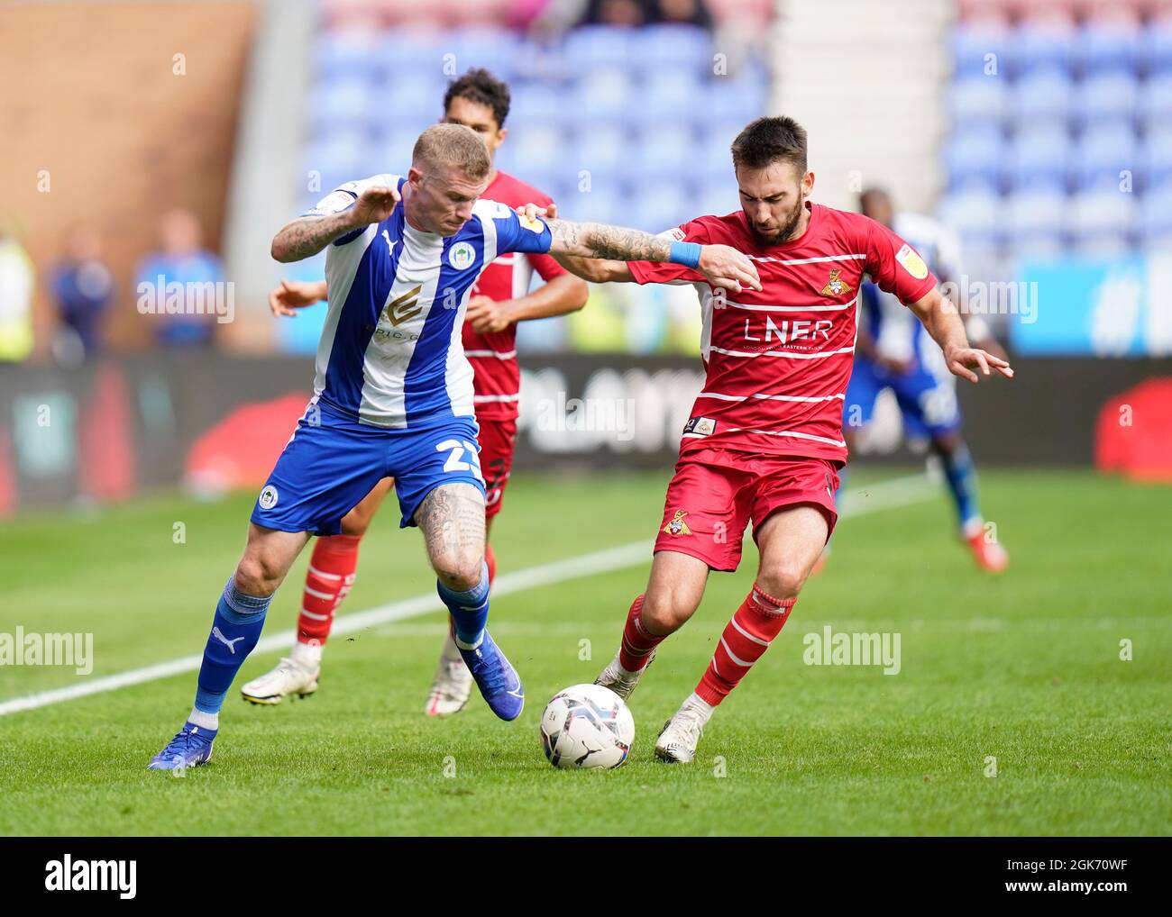 Doncaster's Ben Close competes for the ball with Wigan’s James McClean Wigan Athletic -V- Doncaster Rovers   at The DW Stadium, Wigan, Greater Manches Stock Photo