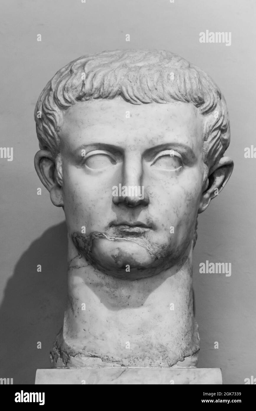 Black and white photo of head in ruins of ancient roman lad sculpted in marble Stock Photo