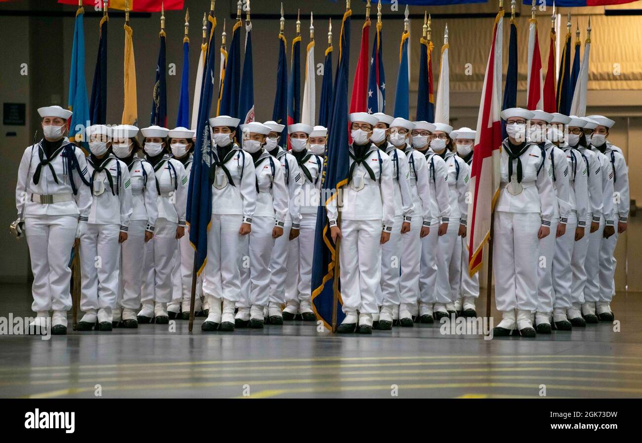Performance division recruits carrying state flags await the signal to begin their presentation in front of guests of a pass-in-review graduation ceremony at Recruit Training Command. More than 40,000 recruits train annually at the Navy's only boot camp. Stock Photo