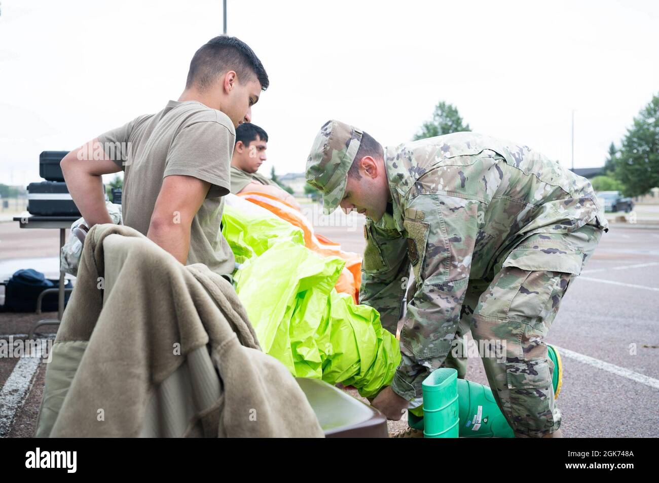 Capt. Daniel Wilkinson, right, 341st Operational Medical Readiness Squadron bioenvironmental engineering flight commander, helps Airman 1st Class Dylan Baggett, left, 341st OMRS bioenvironmental engineer apprentice, don a Level A fully encapsulating suit during a medical readiness exercise Aug. 20, 2021, at Malmstrom Air Force Base, Mont. During the exercise scenario, bioenvironmental was responsible for checking the scene for simulated chemical contaminants. Stock Photo