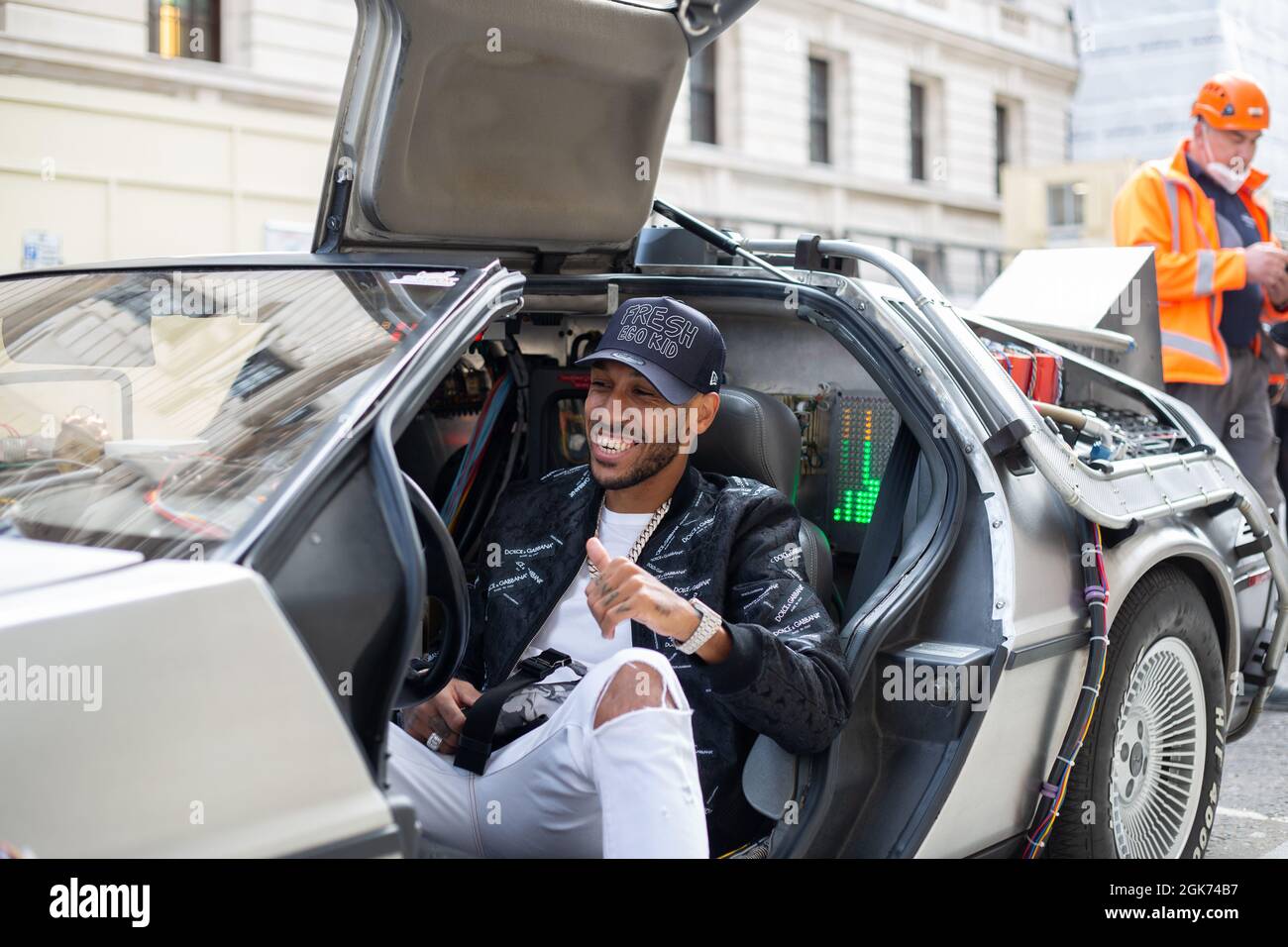 Pierre-Emerick Auameyang sitting in the only official DeLorean time machine from back to future in the uk.in central London Stock Photo