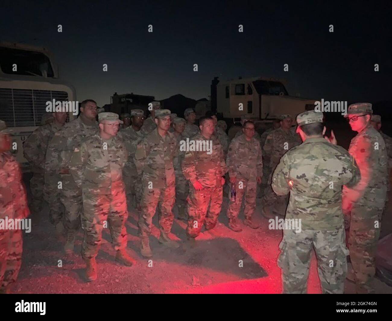 Convoy commander, Spc. Larson, gives convoy brief prior to returning from the Tactical NVG night driving course during annual training for the 257th Transportation Company. Stock Photo