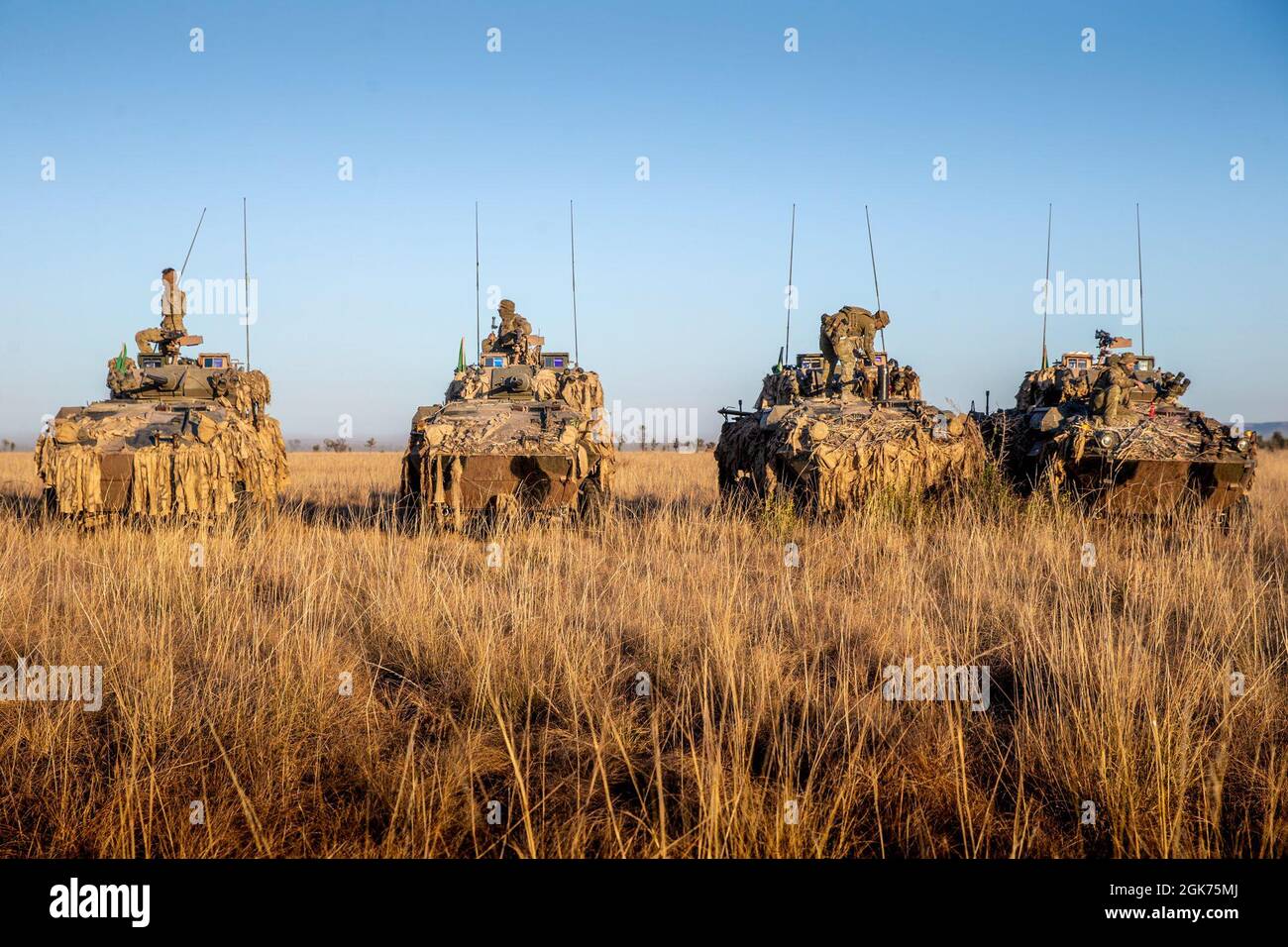 A group of Australian Service Light Armored Vehicles line up to prepare for a live-fire range at Bradshaw Field Training Area, NT, Australia, Aug. 21, 2021. 1st Armored Regiment used this range to zero their weapons in preparation for Exercise Koolendong. Exercise Koolendong validates Marine Rotational Force – Darwin’s and the Australian Defence Force’s ability to conduct expeditionary command and control operations, demonstrating the shared commitment to being ready to respond to a crisis or contingency in the Indo-Pacific region. Stock Photo