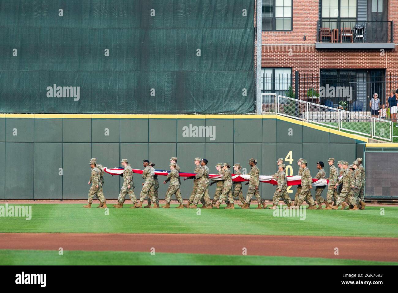 Airmen from Wright-Patterson Air Force Base march a large flag onto the  field during the Dayton Dragons Hometown Heroes event at Day Air Credit  Union Ballpark, Aug. 21, 2021, in Dayton, Ohio.