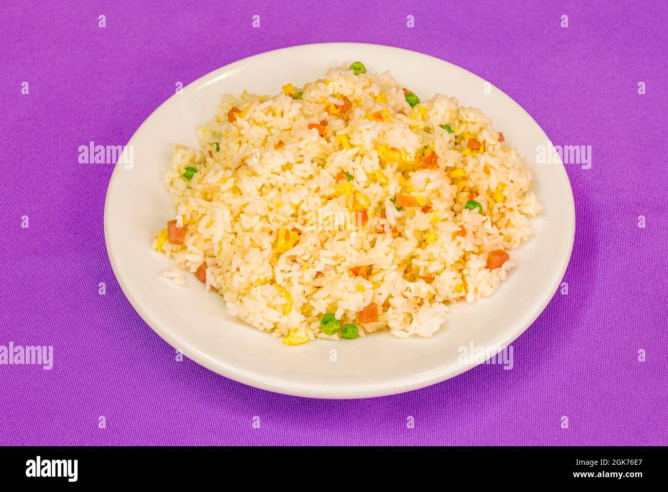 Three delights rice prepared in Chinese restaurant on purple tablecloth Stock Photo