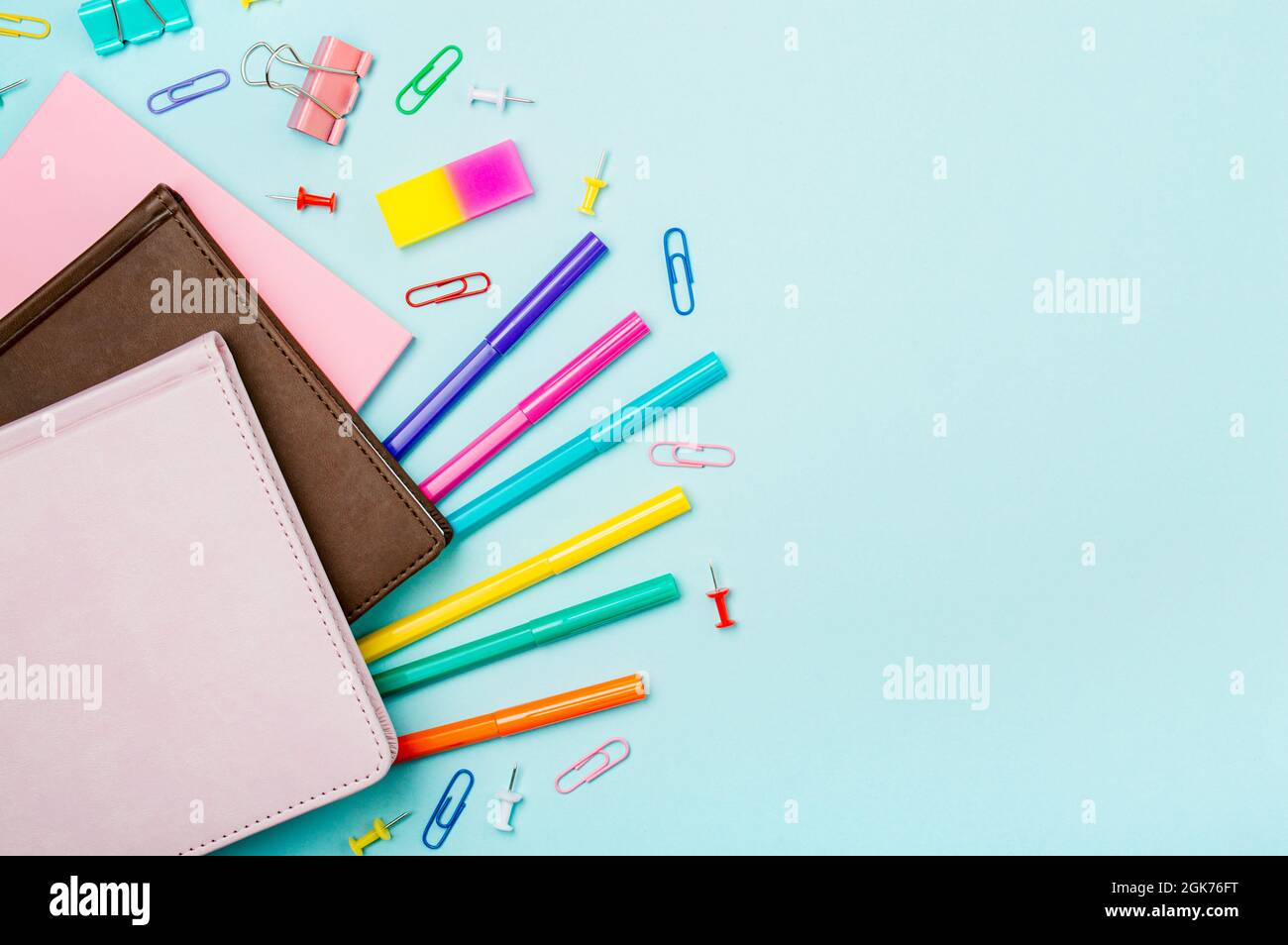 School supplies, stationery accessories on blue background. Copy space. Top view flat lay. Education, back to school, freelancer work concept. Long horizontal banner Stock Photo