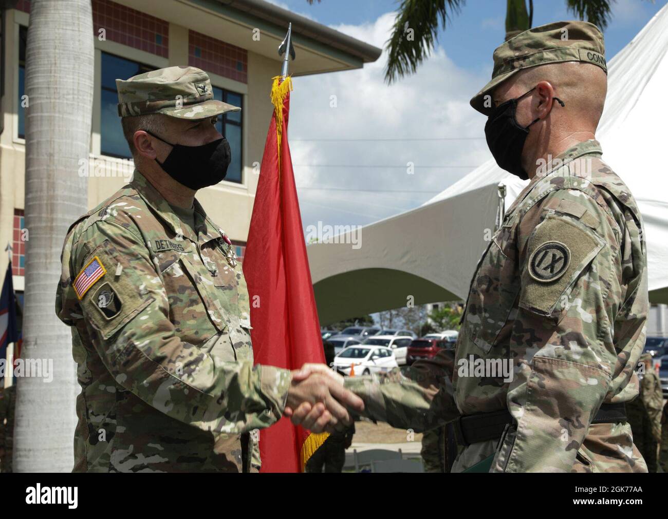 U.S. Army Reserve Col. John Dethlefs shakes 9th Mission Support Command Commander Brig. Gen. Timothy Connelly's hand August 22 2021, at Fort Shafter Flats in Honolulu.  Connelly holds a Bachelor's degree in Economics, a Master's degree in Business Administration, and a Master's degree in Strategic Studies. Stock Photo