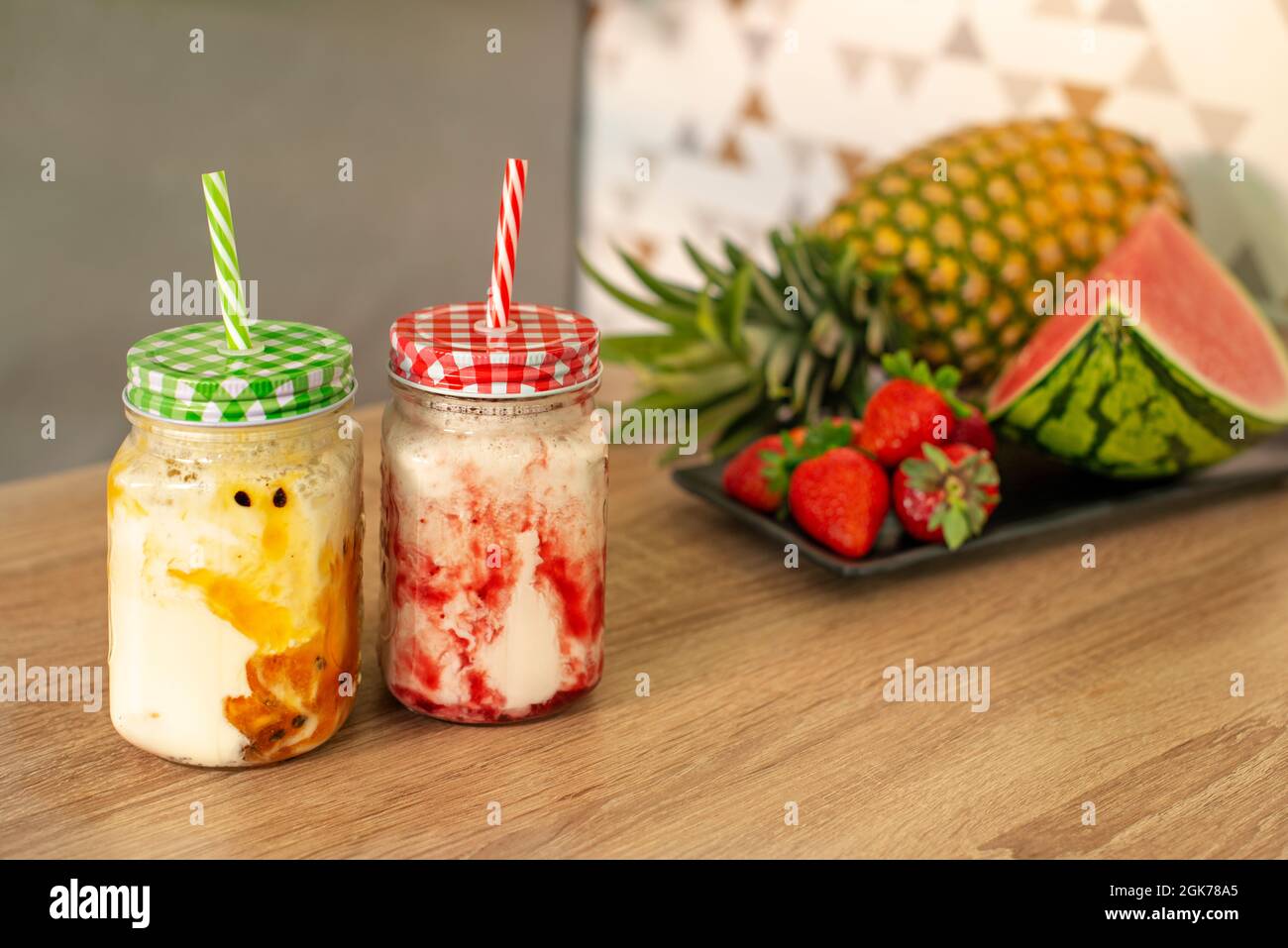 https://c8.alamy.com/comp/2GK78A5/drinking-jugs-with-straw-with-strawberry-and-passion-fruit-juices-and-fresh-fruits-2GK78A5.jpg