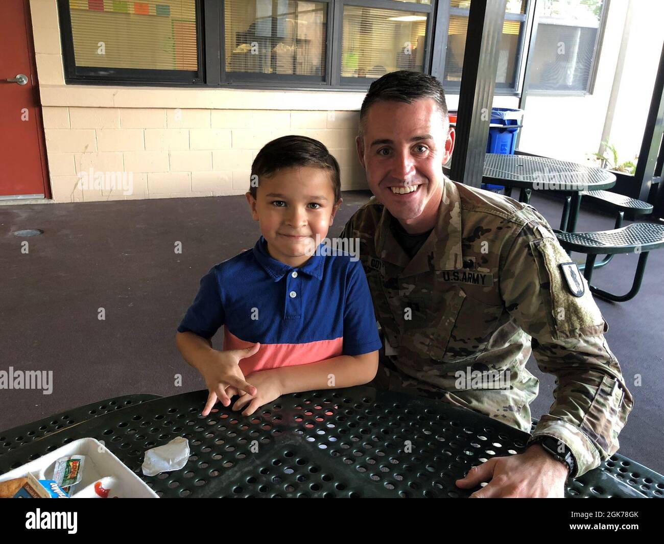 Army Capt. Michael Coy, the Drug Demand Reduction Outreach State Prevention Coordinator for Florida National Guard’s Counterdrug Program joins his Little for lunch at an elementary school in St. Johns County, Florida. Through the Big Brothers Big Sisters program, Coy has mentored this boy for the last two years. Stock Photo