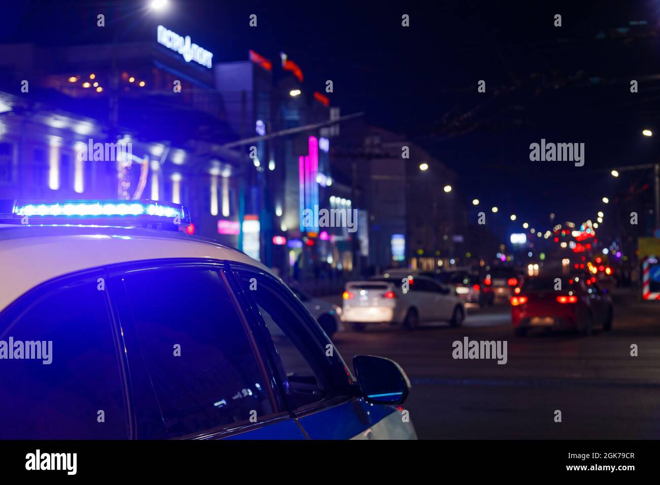 police car lights at night in city with selective focus and blurry car ...