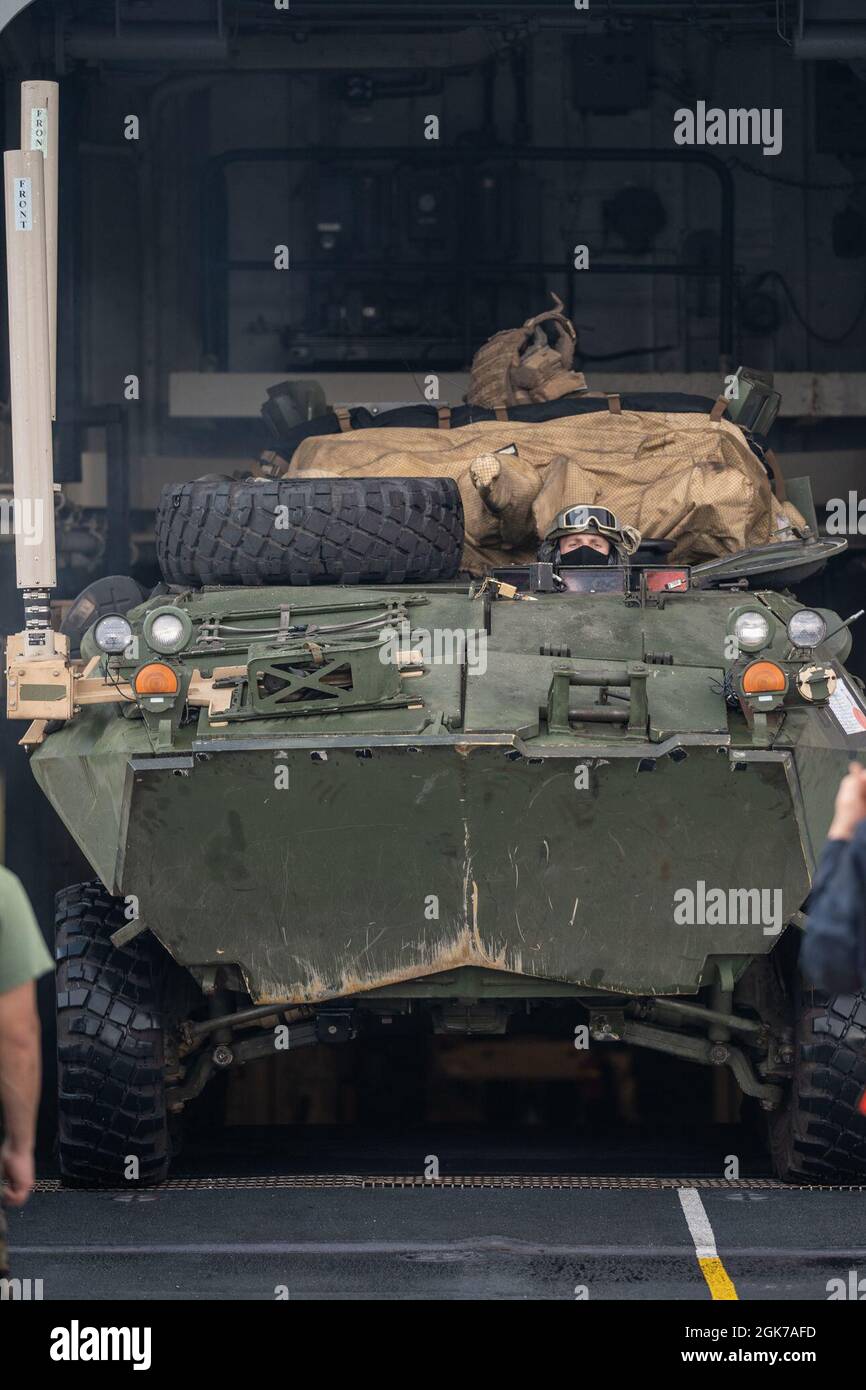 U.S. Marine Corps Cpl. Lawrence Woodwall, a light armored vehicle crewman with Light Armored Reconnaissance Company, Battalion Landing Team 1/1, 11th Marine Expeditionary Unit, drives an LAV-25 into the onto the flight deck of amphibious transport dock USS Portland (LPD 27) during a defense of the amphibious task force rehearsal, Aug. 24, 2021. Portland, part of the USS Essex Amphibious Ready Group, along with the 11th MEU, is operating in the U.S. 7th Fleet area of responsibility to enhance interoperability with allies and partners and serve as a ready response force to defend peace and stabi Stock Photo