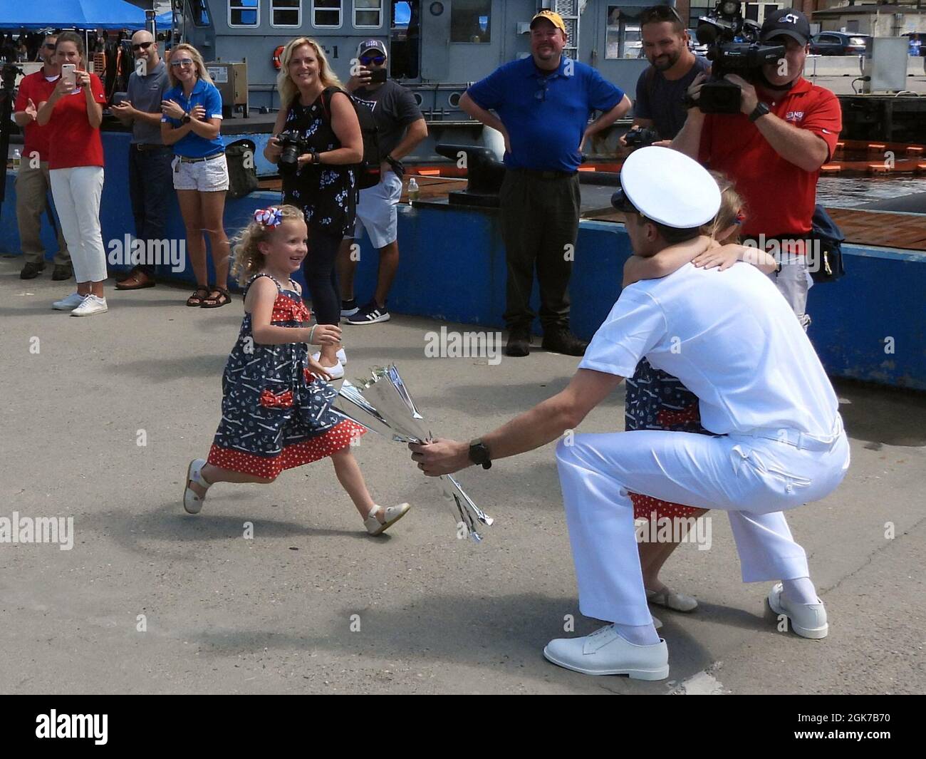210824-N-AY957-070 GROTON, Conn. (August 24, 2021) – A child runs to hug her father, Chief Petty Officer David Begley, a nuclear machinist’s mate from the Los Angeles-class submarine USS San Juan (SSN 751), during a homecoming event at Naval Submarine Base New London in Groton, Conn., Aug. 24. San Juan and crew, operating under Submarine Squadron (SUBRON) TWELVE, returned to homeport from a scheduled seven-month deployment in support of the Navy's maritime strategy of supporting national security interests and maritime security operations. Stock Photo