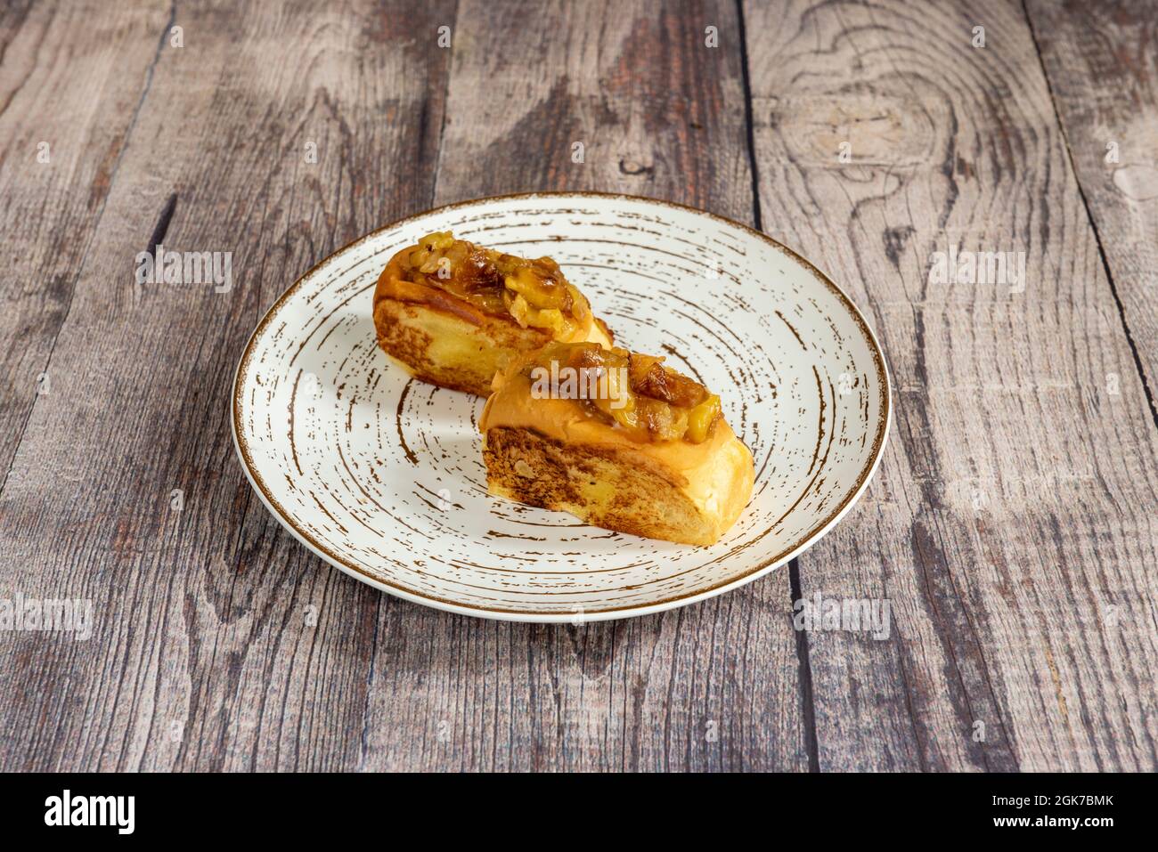 Toasted brioche bread filled with spectacular Spanish potato omelette on white plate Stock Photo