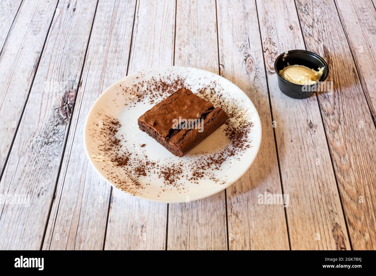 Square dessert portion of chocolate brownie cake with nuts, cocoa