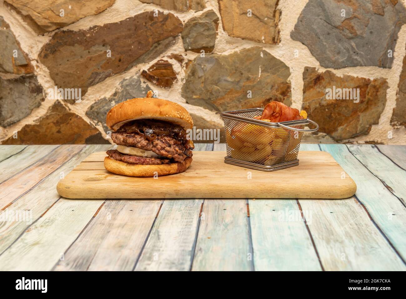 Grilled beef double burger with goat cheese, confit onion, fried bacon