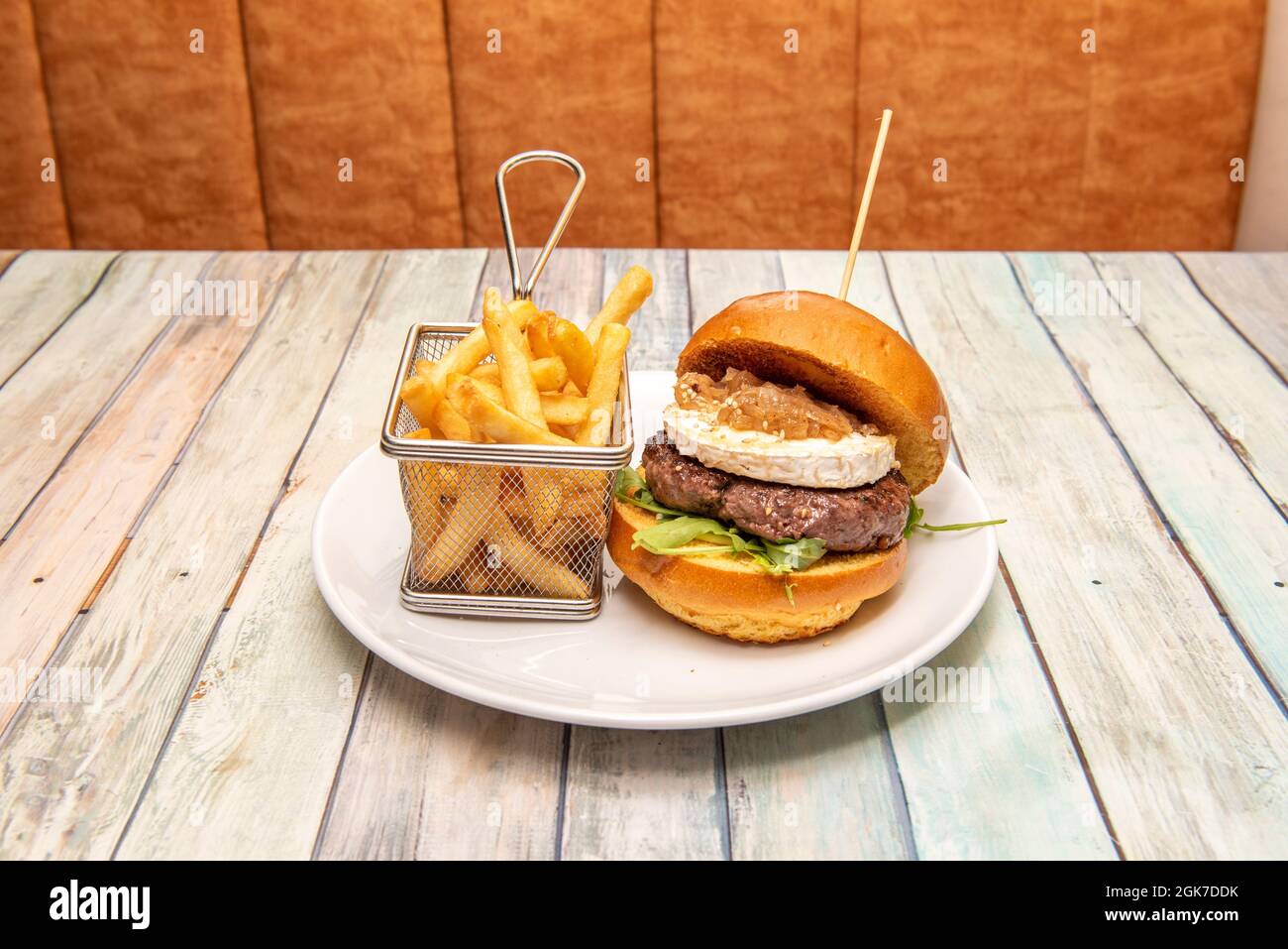 Beef burger with grilled brioche bread, goat cheese, stewed onion