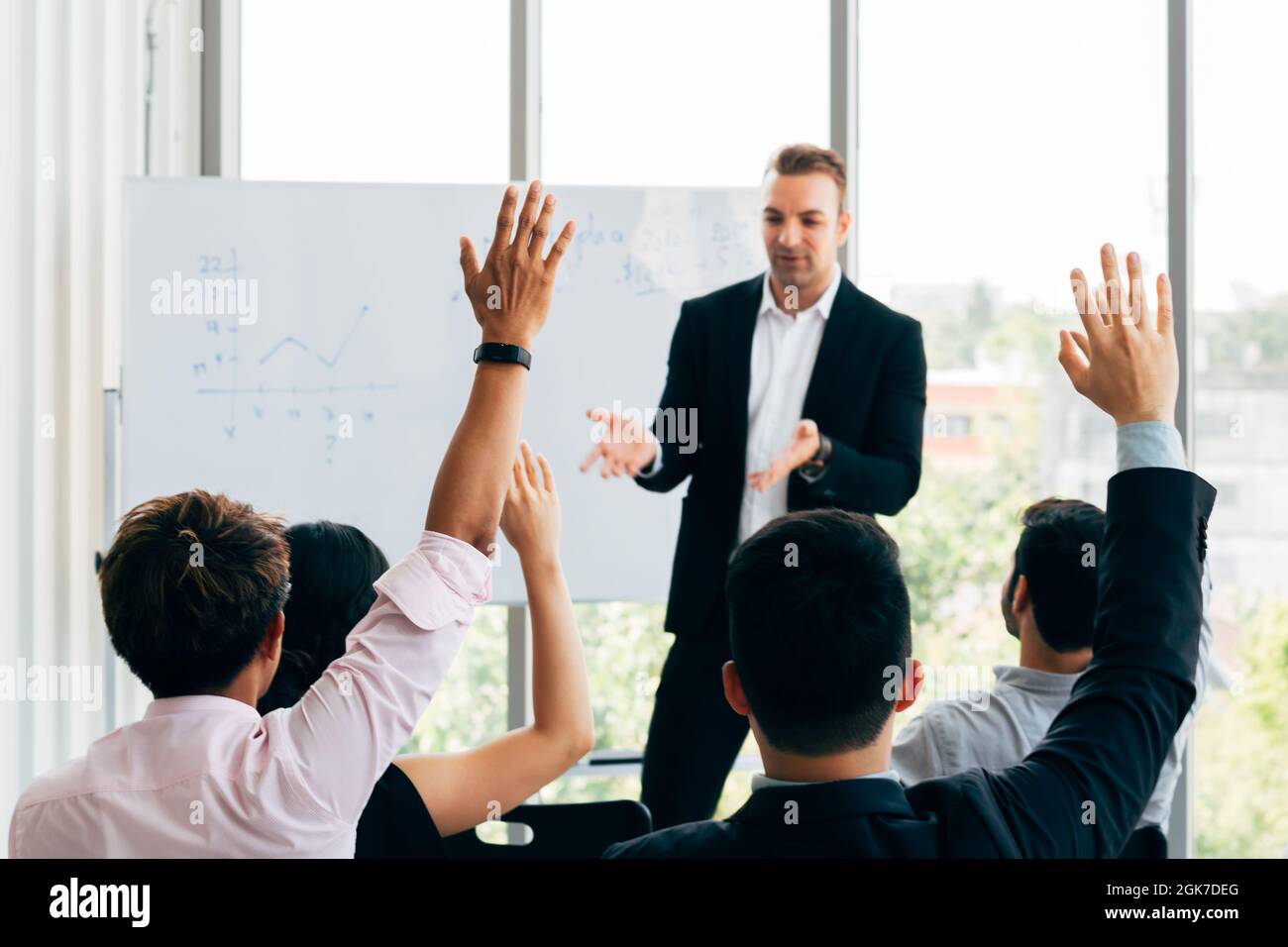 Many business people participants raising up their hand in business ...