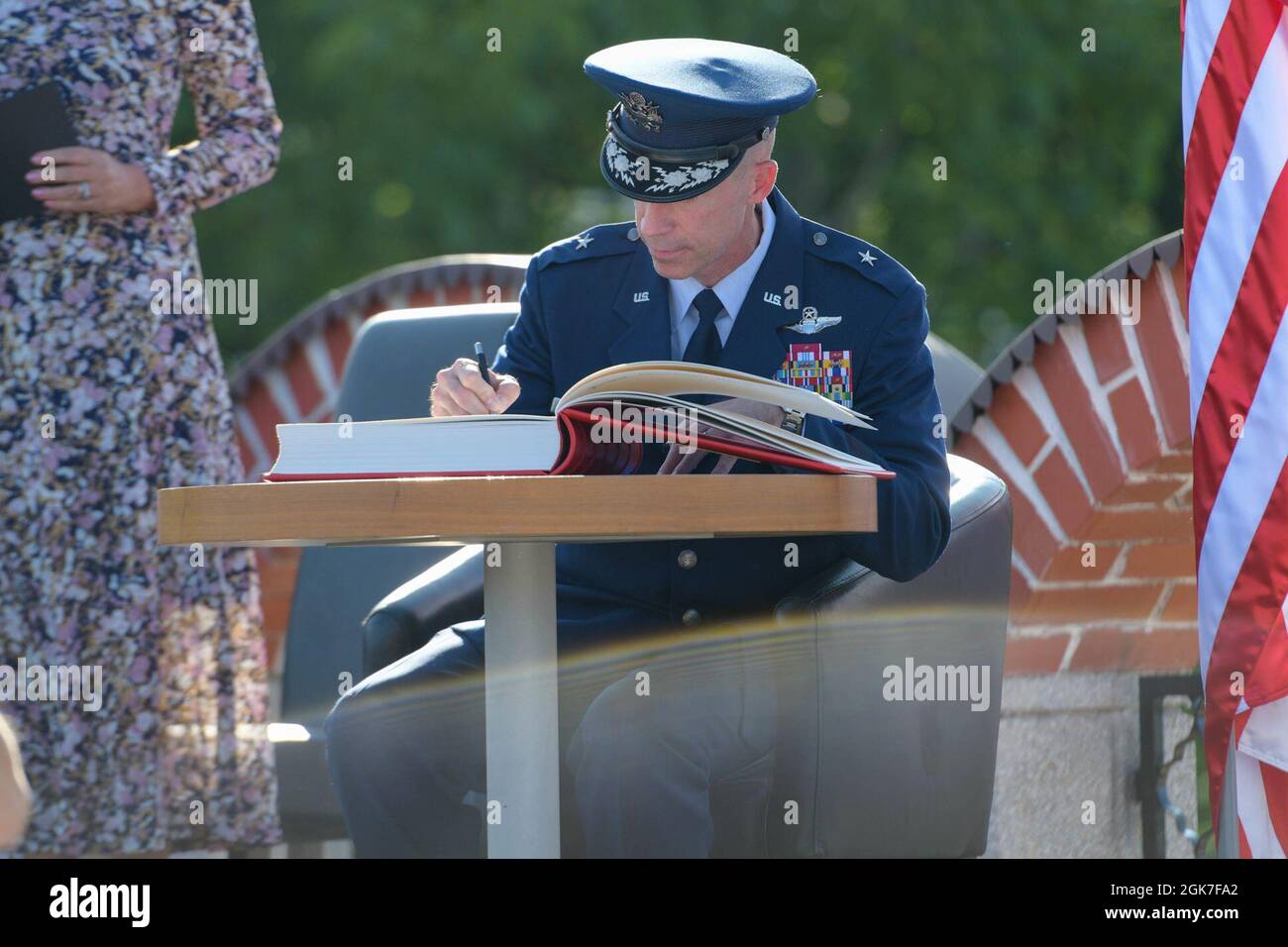 U.S. Air Force Brig. Gen. Jason E. Bailey, 31st Fighter Wing commander, signs a visitor’s book at the Andraž ceremony in Andraž nod Polzelo, Slovenia, Aug. 25, 2021. In 1944, the U.S. B-17 bomber ‘Dark Eyes’ was shot down over Andraž nod Polzelo and the memorial to ‘Dark Eyes’ was dedicated on March 22, 2014. ‘Dark Eyes,’ is an American B-17 bomber that flew 80 missions during World War II in the skies above occupied France, Italy, and Nazi Germany. Stock Photo