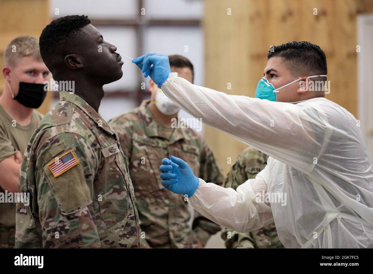army cpl jonathan leon camacho a practical nursing specialist with dwight d eisenhower army medical center at fort gordon tests a soldier from 447th military police company for the covid virus aug 25 2021 at camp shelby joint training center miss testing was done to ensure heath and readiness for the soldiers upcoming mission and limit the spread of the virus 2GK7FC5